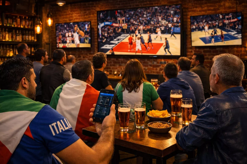 Tifosi italiani in un moderno sports bar che guardano partite di basket sui grandi schermi